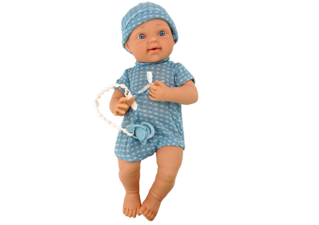 Babypuppe in blauer Kleidung, Mütze, Schnuller und Decke