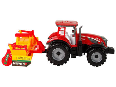 Roter Traktor mit orangefarbenem Grubberantrieb